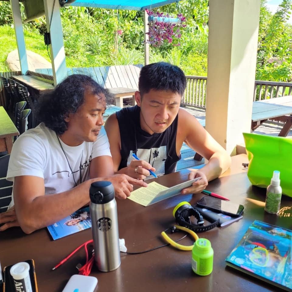 Dive instructor teaching new PADI Open water course student at Bigfin beach resort Kota Belud Sabah